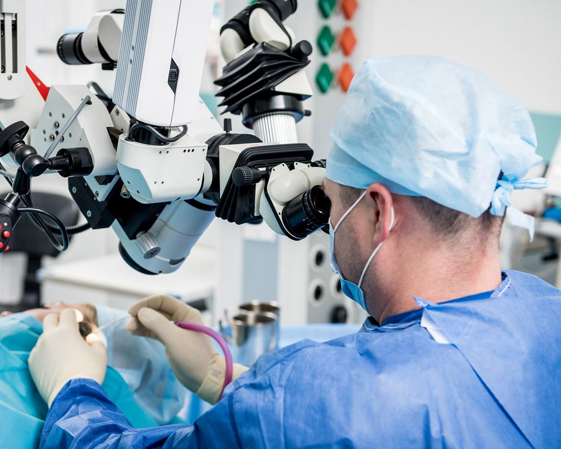 Surgeon performing ear surgery using an operating microscope